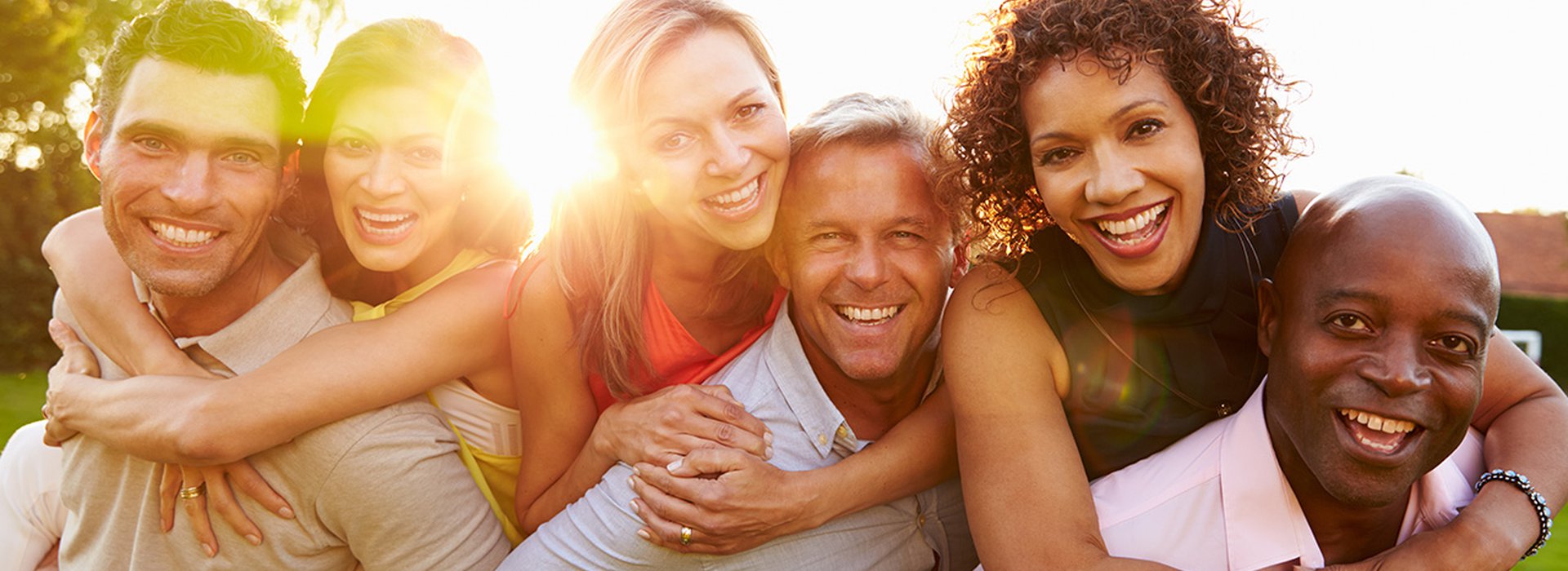 Portrait Of Mature Men Giving Women Piggy Backs